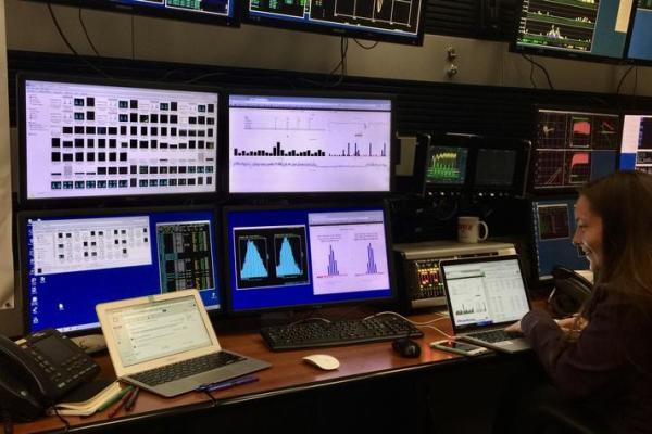 Researcher looks at computer screens