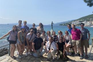 Students with faculty in front of water