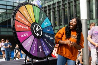 Student smiles as she spins wheel with countries