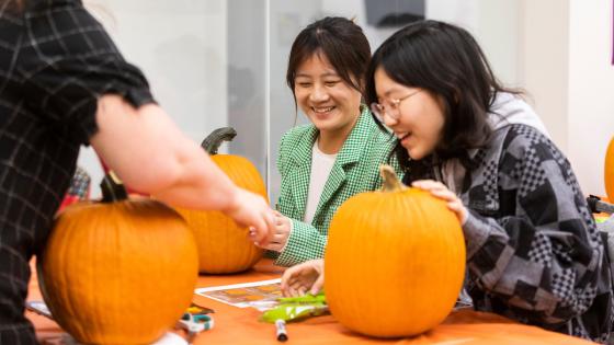 students carving pumpkins