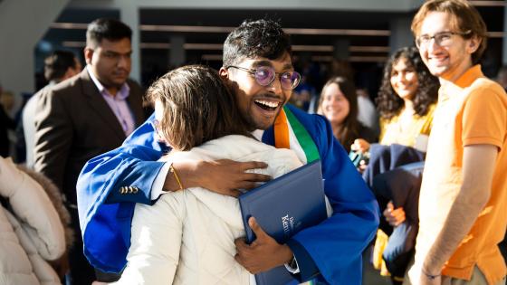 Graduate hugs family