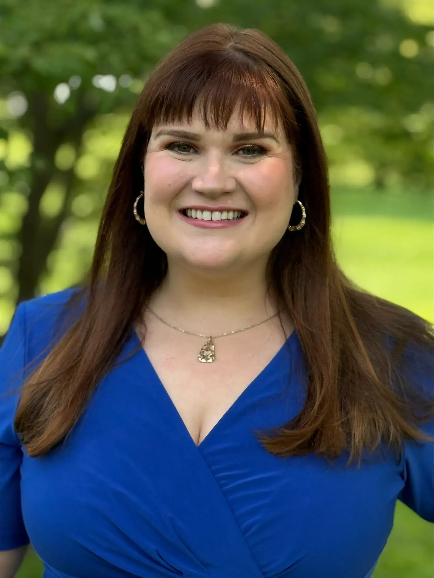 Ashley McQueary smiles wearing a blue top